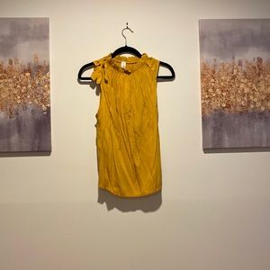 Shirt with bow tie on right shoulder, ruffled neck line.